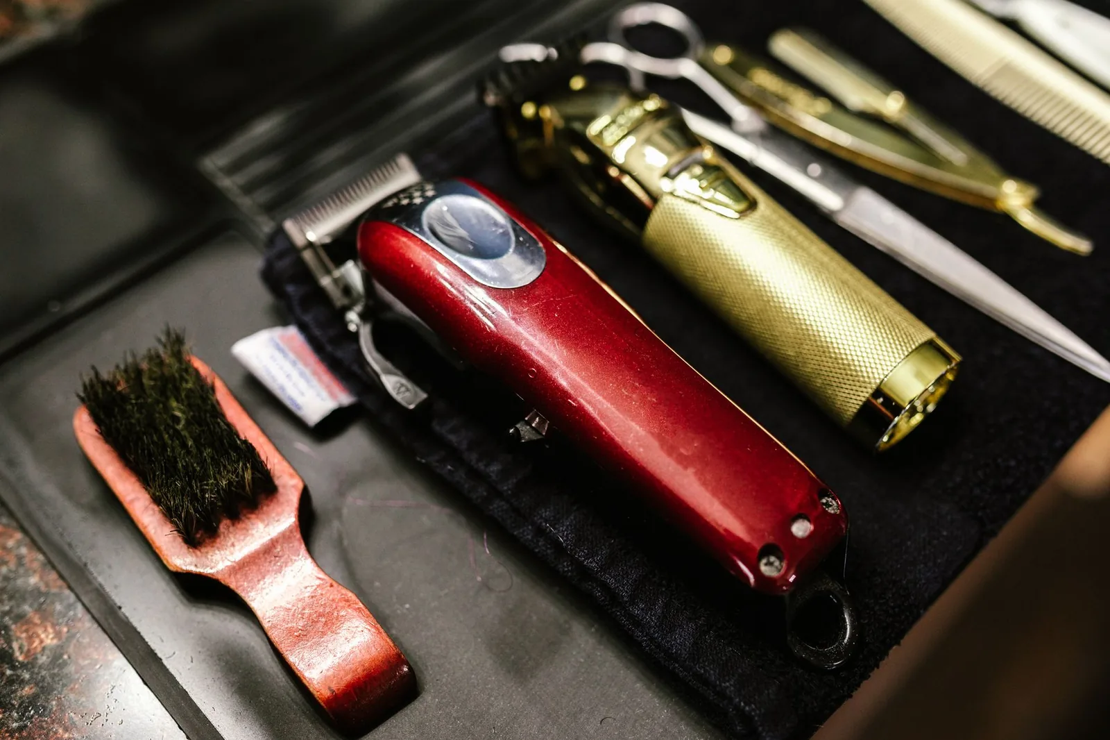 Clippers, a trimmer, razor and brush on a towel