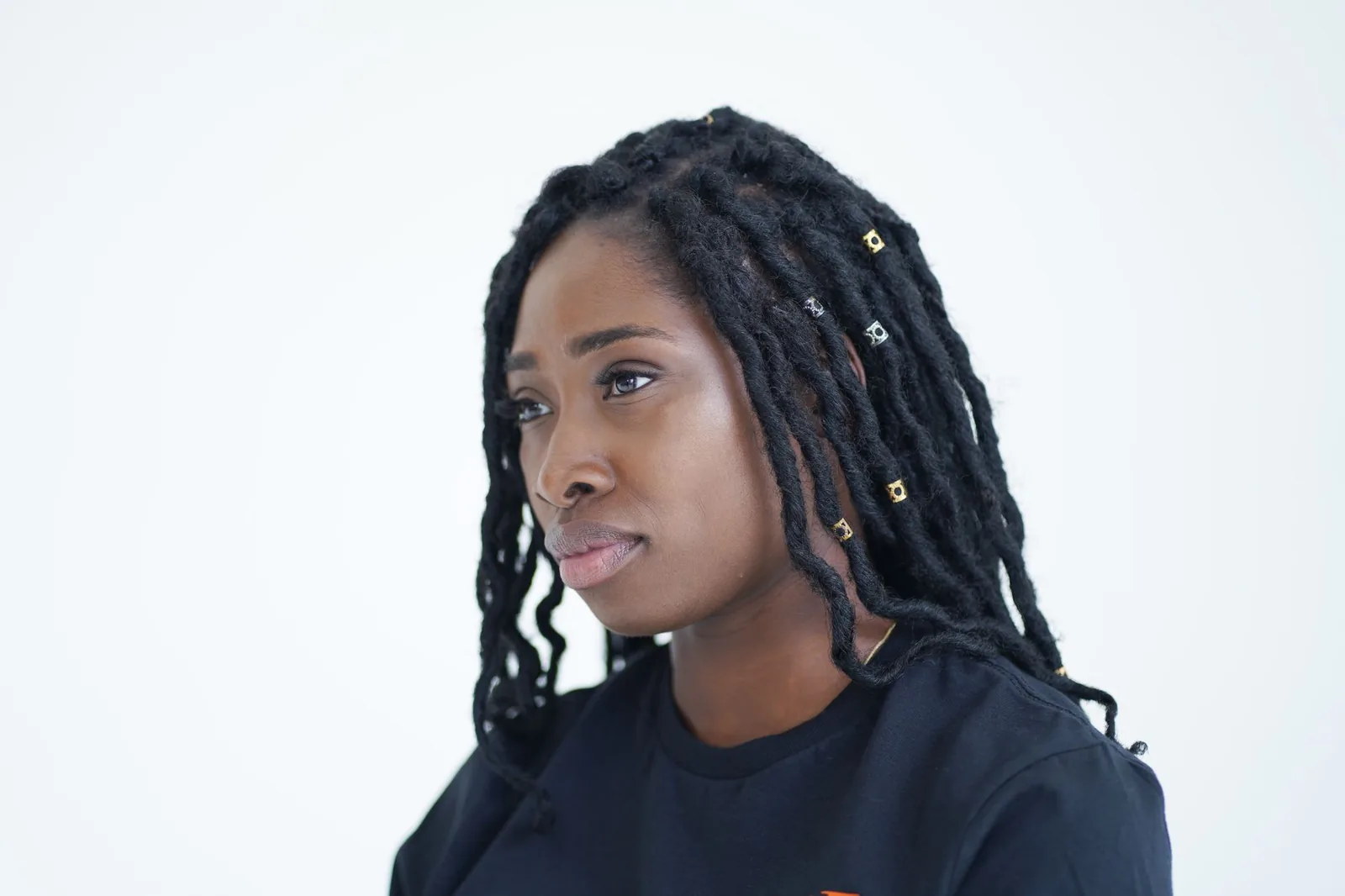 A woman with locs and beaded hair accessories