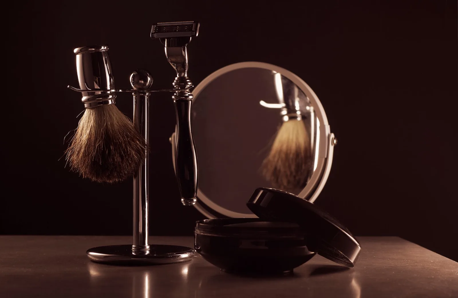 Shaving brush and razor on a stand with a mirror